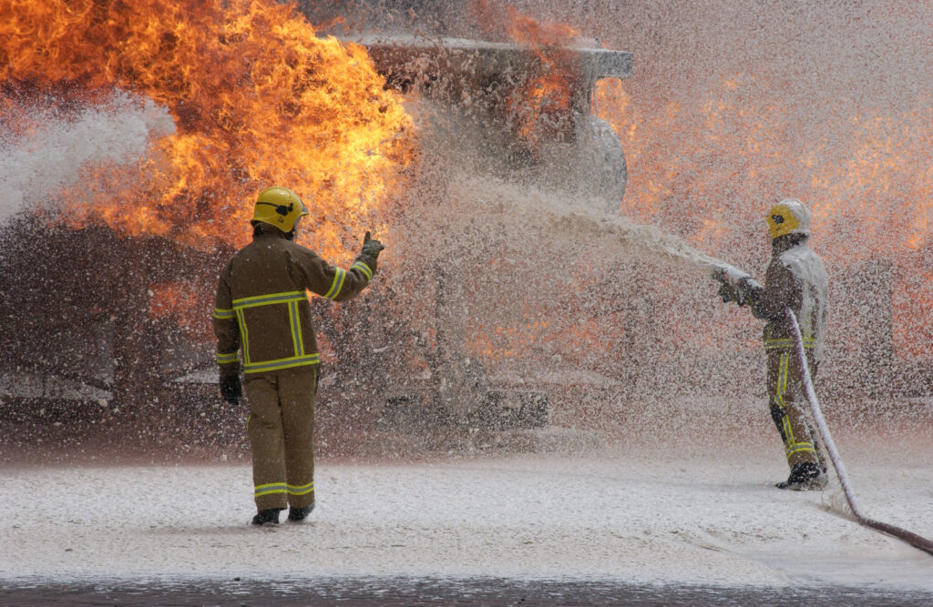 firefighting team fighting a fire with AFFF firefighting foam