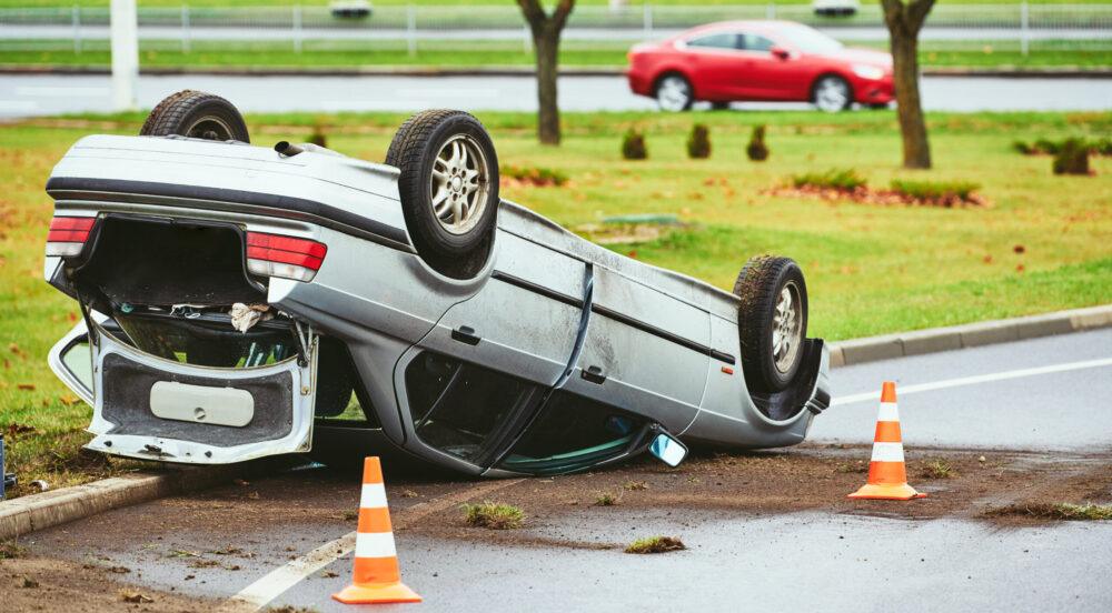 car crash accident. Car collision on city street. damaged automobile laying upside down
