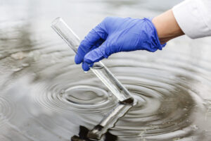 scientist taking sample of contaminated water