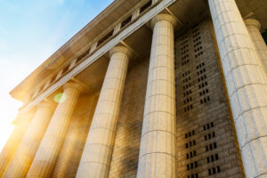 courthouse bottom-up view with sunning shining in the background