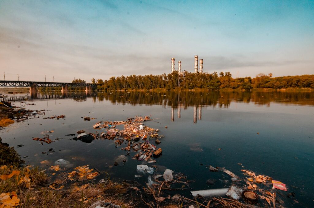 contaminated river with a power plant in the background