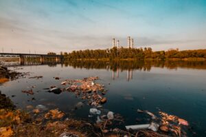 contaminated river with a power plant in the background