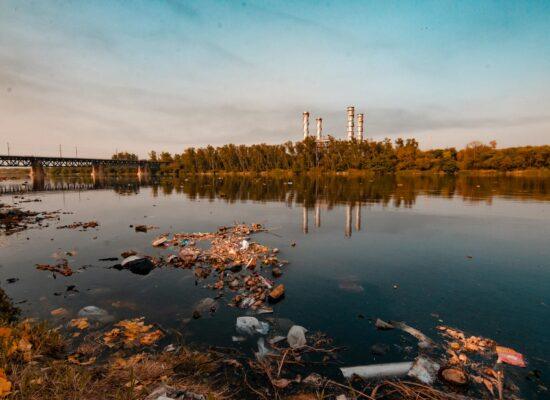 contaminated river with a power plant in the background