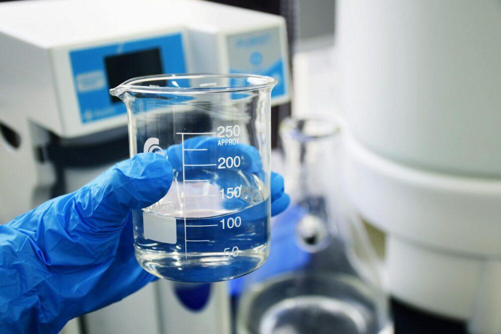 Water in a glass beaker being tested for 1,4 Dioxane