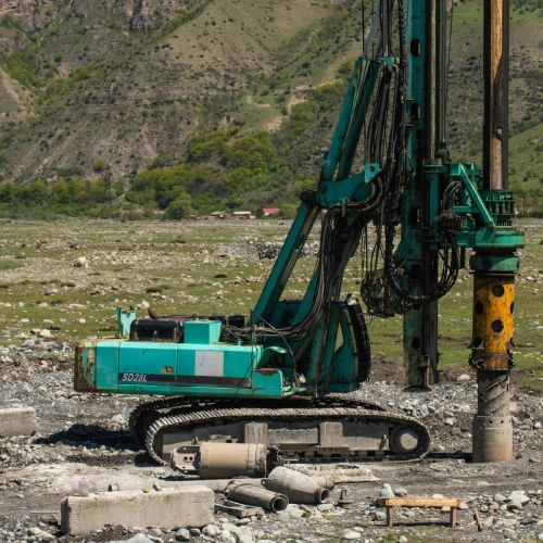 a drilling rig drilling into the earth at a job site