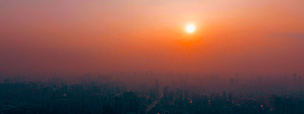 air pollution over a city at sunset