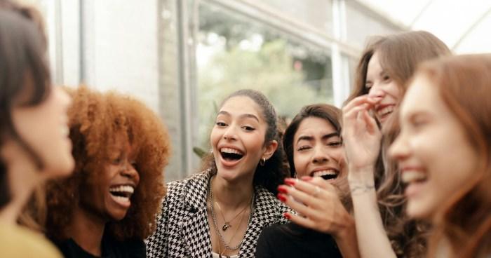 a group of women talking and laughing together