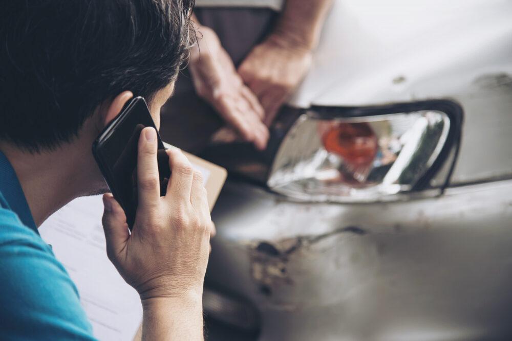 person making a phone call following a car accident