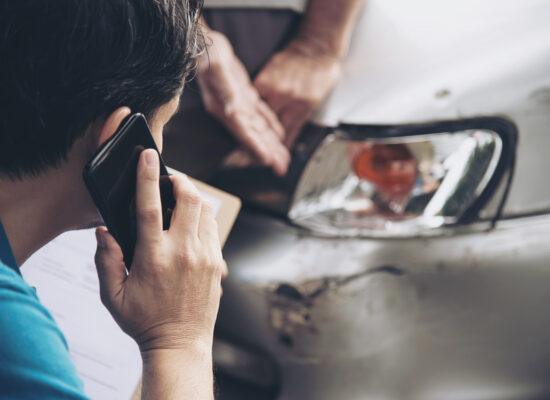 person making a phone call following a car accident